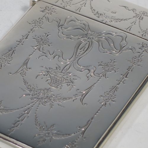 A very pretty Antique Sterling Silver calling card case, having a rectangular body with rounded shoulders, hand-engraved neoclassical style floral decoration on the front with a plain undecorated rear side, and a side-hinged lid. Made by Crisford and Norris Ltd., of Birmingham in 1913. The dimensions of this fine hand-made antique silver card case are length 10 cms (4 inches), width 7 cms (2.75 inches), and it weighs approx. 67g (2.2 troy ounces).