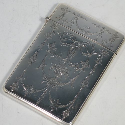 A very pretty Antique Sterling Silver calling card case, having a rectangular body with rounded shoulders, hand-engraved neoclassical style floral decoration on the front with a plain undecorated rear side, and a side-hinged lid. Made by Crisford and Norris Ltd., of Birmingham in 1913. The dimensions of this fine hand-made antique silver card case are length 10 cms (4 inches), width 7 cms (2.75 inches), and it weighs approx. 67g (2.2 troy ounces).