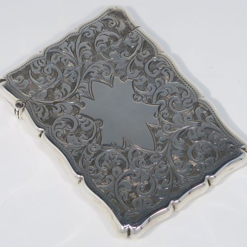 A very pretty Antique Sterling Silver calling card case, having a shaped rectangular body with hand-engraved floral and scroll decoration, a vacant central cartouche on one side, and a side-hinged lid. This beautiful silver card case was made by Smith and Bartlam of Birmingham in 1918. The dimensions of this fine hand-made antique silver card case are length 10 cms (4 inches), width 7 cms (2.75 inches), and it weighs approx. 69g (2.2 troy ounces).   