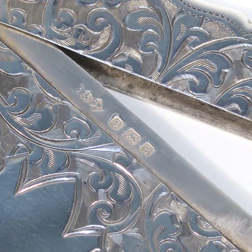 A very pretty Antique Sterling Silver calling card case, having a shaped rectangular body with hand-engraved floral and scroll decoration, a vacant central cartouche on one side, and a side-hinged lid. This beautiful silver card case was made by Smith and Bartlam of Birmingham in 1918. The dimensions of this fine hand-made antique silver card case are length 10 cms (4 inches), width 7 cms (2.75 inches), and it weighs approx. 69g (2.2 troy ounces).