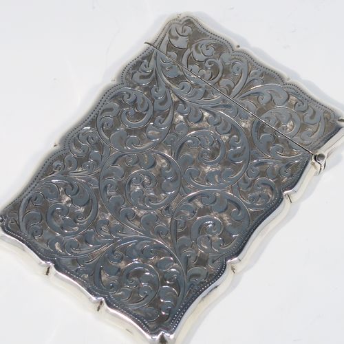 A very pretty Antique Sterling Silver calling card case, having a shaped rectangular body with hand-engraved floral and scroll decoration, a vacant central cartouche on one side, and a side-hinged lid. This beautiful silver card case was made by Smith and Bartlam of Birmingham in 1918. The dimensions of this fine hand-made antique silver card case are length 10 cms (4 inches), width 7 cms (2.75 inches), and it weighs approx. 69g (2.2 troy ounces).