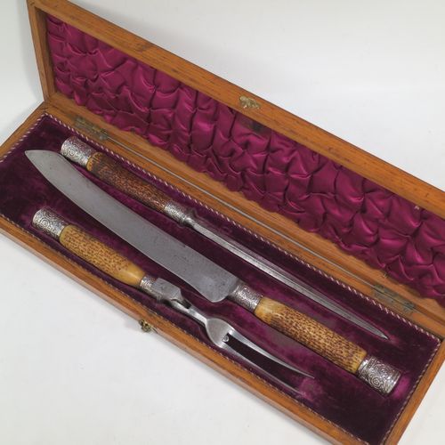 A very handsome and complete Antique Victorian Sterling Silver and deer antler horn carving set, consisting of a fork with guard, one carving knife, and one sharpening steel, with original bone antler handles and silver ferrules with hand-chased floral-work, all in their original maroon silk and velvet-lined presentation oak box. Made by Jonathan Bell of Sheffield in 1869. The dimensions of this fine hand-made antique silver and bone handled carving set are length of knife 41 cms (16 inches), length of fork 29 cms (11.5 inches), and length of steel 35 cms (13.75 inches).