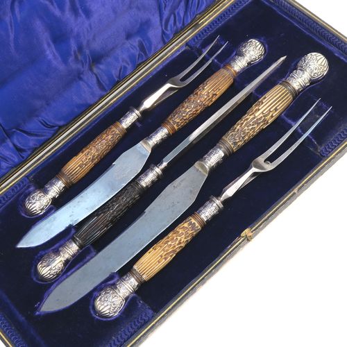 A very handsome, large, and complete Antique Victorian Sterling Silver and deer antler horn carving set, consisting of two forks with working guards, two knives, and one sharpening steel, with original bone antler handles and silver ferrules with hand-chased fluting and floral decoration, all in their original dark blue silk and velvet-lined presentation box. This fantastic original carving set was made by William Yates of Sheffield in 1899. The dimensions of this fine hand-made antique silver and bone handled carving set are length of longest knife 37 cms (14.5 inches), and length of shortest fork 27 cms (10.5 inches). Please note that the exterior of the box is slightly damaged and the lid is warped, although it does close shut properly.
