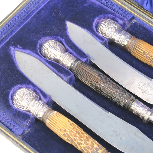 A very handsome, large, and complete Antique Victorian Sterling Silver and deer antler horn carving set, consisting of two forks with working guards, two knives, and one sharpening steel, with original bone antler handles and silver ferrules with hand-chased fluting and floral decoration, all in their original dark blue silk and velvet-lined presentation box. This fantastic original carving set was made by William Yates of Sheffield in 1899. The dimensions of this fine hand-made antique silver and bone handled carving set are length of longest knife 37 cms (14.5 inches), and length of shortest fork 27 cms (10.5 inches). Please note that the exterior of the box is slightly damaged and the lid is warped, although it does close shut properly.