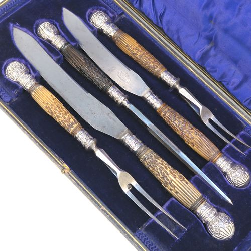 A very handsome, large, and complete Antique Victorian Sterling Silver and deer antler horn carving set, consisting of two forks with working guards, two knives, and one sharpening steel, with original bone antler handles and silver ferrules with hand-chased fluting and floral decoration, all in their original dark blue silk and velvet-lined presentation box. This fantastic original carving set was made by William Yates of Sheffield in 1899. The dimensions of this fine hand-made antique silver and bone handled carving set are length of longest knife 37 cms (14.5 inches), and length of shortest fork 27 cms (10.5 inches). Please note that the exterior of the box is slightly damaged and the lid is warped, although it does close shut properly.