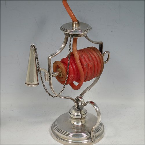 An Antique Victorian Silver Plated wax-jack chamber-stick, having a round base and top, with a wire-work frame, a scroll handle, all with hand-chased reeded borders, an attached snuffer on chain, and all in original condition. Made by Mappin & Webb in ca. 1890. The dimensions of this fine hand-made antique silver-plated waxjack chamberstick are diameter at base 8 cms (3 inches), and height 16 cms (6.25 inches).
	   