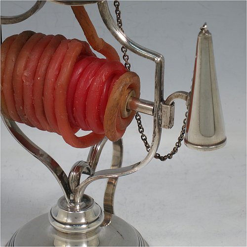 An Antique Victorian Silver Plated wax-jack chamber-stick, having a round base and top, with a wire-work frame, a scroll handle, all with hand-chased reeded borders, an attached snuffer on chain, and all in original condition. Made by Mappin & Webb in ca. 1890. The dimensions of this fine hand-made antique silver-plated waxjack chamberstick are diameter at base 8 cms (3 inches), and height 16 cms (6.25 inches).
