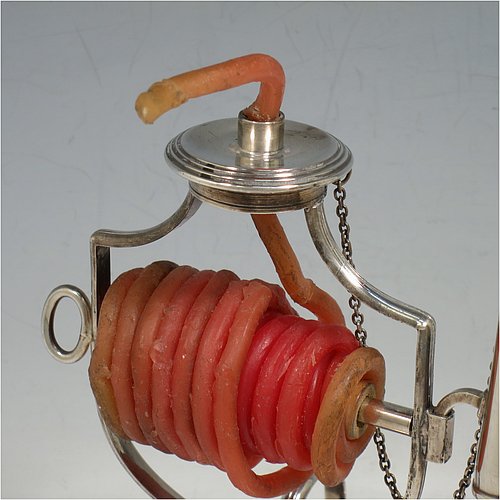 An Antique Victorian Silver Plated wax-jack chamber-stick, having a round base and top, with a wire-work frame, a scroll handle, all with hand-chased reeded borders, an attached snuffer on chain, and all in original condition. Made by Mappin & Webb in ca. 1890. The dimensions of this fine hand-made antique silver-plated waxjack chamberstick are diameter at base 8 cms (3 inches), and height 16 cms (6.25 inches).