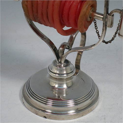 An Antique Victorian Silver Plated wax-jack chamber-stick, having a round base and top, with a wire-work frame, a scroll handle, all with hand-chased reeded borders, an attached snuffer on chain, and all in original condition. Made by Mappin & Webb in ca. 1890. The dimensions of this fine hand-made antique silver-plated waxjack chamberstick are diameter at base 8 cms (3 inches), and height 16 cms (6.25 inches).