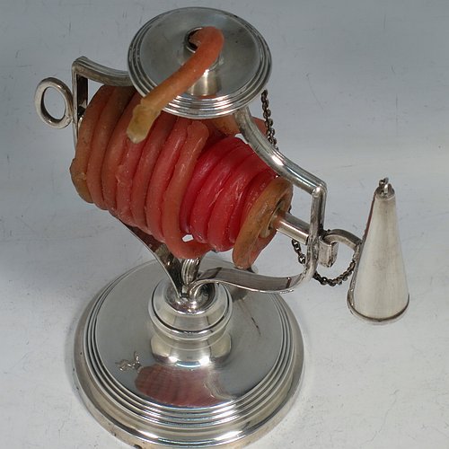 An Antique Victorian Silver Plated wax-jack chamber-stick, having a round base and top, with a wire-work frame, a scroll handle, all with hand-chased reeded borders, an attached snuffer on chain, and all in original condition. Made by Mappin & Webb in ca. 1890. The dimensions of this fine hand-made antique silver-plated waxjack chamberstick are diameter at base 8 cms (3 inches), and height 16 cms (6.25 inches).
