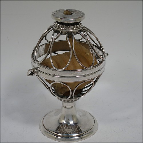 An Antique Georgian Old Sheffield Silver Plated wax-jack chamber-stick in a globe style, having a coiled wax mounted in a spherical boy with a wire-work frame, sitting on a plain round pedestal foot, with hand-chased reeded borders, all in original condition. Made in ca. 1800. The dimensions of this fine hand-made antique Old Sheffield silver-plated waxjack chamberstick are height 13.5 cms (5.5 inches), and diameter 7.5 cms (3 inches).
	   