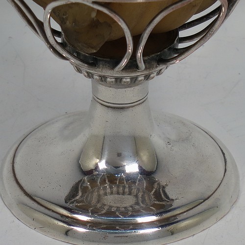An Antique Georgian Old Sheffield Silver Plated wax-jack chamber-stick in a globe style, having a coiled wax mounted in a spherical boy with a wire-work frame, sitting on a plain round pedestal foot, with hand-chased reeded borders, all in original condition. Made in ca. 1800. The dimensions of this fine hand-made antique Old Sheffield silver-plated waxjack chamberstick are height 13.5 cms (5.5 inches), and diameter 7.5 cms (3 inches).