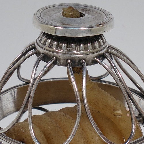 An Antique Georgian Old Sheffield Silver Plated wax-jack chamber-stick in a globe style, having a coiled wax mounted in a spherical boy with a wire-work frame, sitting on a plain round pedestal foot, with hand-chased reeded borders, all in original condition. Made in ca. 1800. The dimensions of this fine hand-made antique Old Sheffield silver-plated waxjack chamberstick are height 13.5 cms (5.5 inches), and diameter 7.5 cms (3 inches).