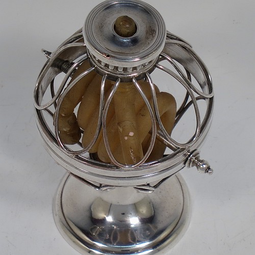 An Antique Georgian Old Sheffield Silver Plated wax-jack chamber-stick in a globe style, having a coiled wax mounted in a spherical boy with a wire-work frame, sitting on a plain round pedestal foot, with hand-chased reeded borders, all in original condition. Made in ca. 1800. The dimensions of this fine hand-made antique Old Sheffield silver-plated waxjack chamberstick are height 13.5 cms (5.5 inches), and diameter 7.5 cms (3 inches).