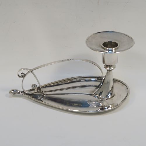 A very individual Scottish Sterling Silver modernistic style chamber-stick, having a plain oval leaf-form body, with a scroll-work handle, a plain round fixed nozzle, and sitting on a flat base. This unusual silver chamberstick was made in Edinburgh in 2008. The dimensions of these fine hand-made silver chambersticks are length 18 cms (7 inches), width 10 cms (4 inches), height 9 cms (3.5 inches), and it weighs approx. 162g (5.2 troy ounces).   