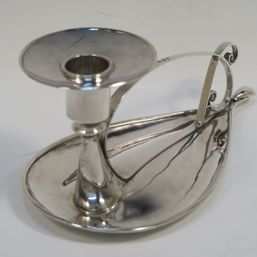A very individual Scottish Sterling Silver modernistic style chamber-stick, having a plain oval leaf-form body, with a scroll-work handle, a plain round fixed nozzle, and sitting on a flat base. This unusual silver chamberstick was made in Edinburgh in 2008. The dimensions of these fine hand-made silver chambersticks are length 18 cms (7 inches), width 10 cms (4 inches), height 9 cms (3.5 inches), and it weighs approx. 162g (5.2 troy ounces).