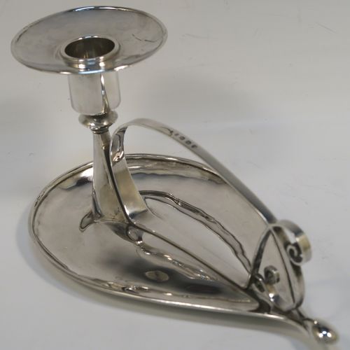 A very individual Scottish Sterling Silver modernistic style chamber-stick, having a plain oval leaf-form body, with a scroll-work handle, a plain round fixed nozzle, and sitting on a flat base. This unusual silver chamberstick was made in Edinburgh in 2008. The dimensions of these fine hand-made silver chambersticks are length 18 cms (7 inches), width 10 cms (4 inches), height 9 cms (3.5 inches), and it weighs approx. 162g (5.2 troy ounces).
