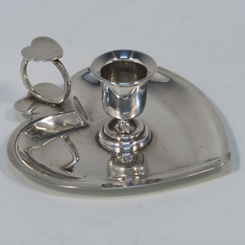 A very pretty Antique Victorian Sterling Silver miniature chamber-stick, having a plain heart-shaped  body, with a ring handle and heart-shaped thumb-piece, a plain round fixed nozzle, and sitting on a flat base. This unusual heart-shaped silver chamberstick was made by William Aitkens of Chester in 1899. The dimensions of these fine hand-made antique silver miniature chamberstick are length 10 cms (4 inches), width 9.5 cms (3.75 inches), height 4 cms (1.5 inches), and it weighs approx. 52g (1.7 troy ounces).  