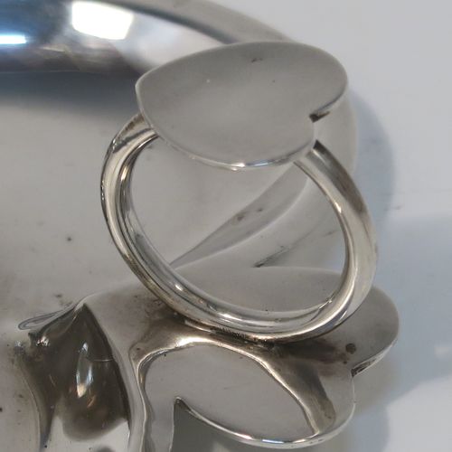 A very pretty Antique Victorian Sterling Silver miniature chamber-stick, having a plain heart-shaped body, with a ring handle and heart-shaped thumb-piece, a plain round fixed nozzle, and sitting on a flat base. This unusual heart-shaped silver chamberstick was made by William Aitkens of Chester in 1899. The dimensions of these fine hand-made antique silver miniature chamberstick are length 10 cms (4 inches), width 9.5 cms (3.75 inches), height 4 cms (1.5 inches), and it weighs approx. 52g (1.7 troy ounces).