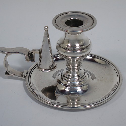 An Antique Victorian Sterling Silver small chamber-stick, having a plain body with a round base, a cast plain scroll handle, an original removable dunce-cap extinguisher, an original removable nozzle, and with applied reed-edged borders. Made by Samuel Hayne and Dudley Cater of London in 1850. The dimensions of this fine hand-made antique silver chamberstick are diameter 10 cms (4 inches), height 7 cms (2.75 inches), and it weighs approx. 179g (5.8 troy ounces).    