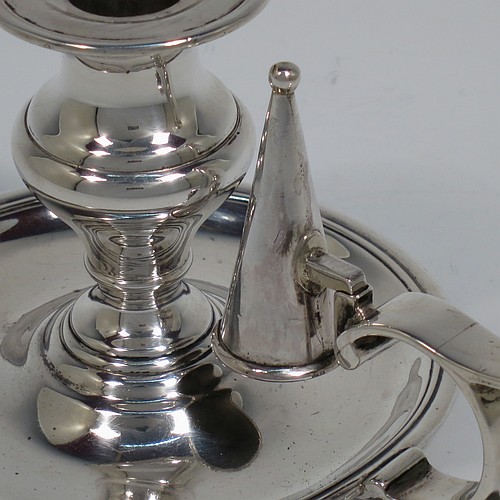 An Antique Victorian Sterling Silver small chamber-stick, having a plain body with a round base, a cast plain scroll handle, an original removable dunce-cap extinguisher, an original removable nozzle, and with applied reed-edged borders. Made by Samuel Hayne and Dudley Cater of London in 1850. The dimensions of this fine hand-made antique silver chamberstick are diameter 10 cms (4 inches), height 7 cms (2.75 inches), and it weighs approx. 179g (5.8 troy ounces).