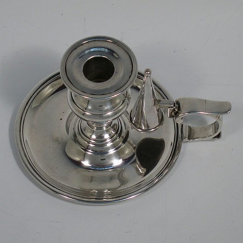 An Antique Victorian Sterling Silver small chamber-stick, having a plain body with a round base, a cast plain scroll handle, an original removable dunce-cap extinguisher, an original removable nozzle, and with applied reed-edged borders. Made by Samuel Hayne and Dudley Cater of London in 1850. The dimensions of this fine hand-made antique silver chamberstick are diameter 10 cms (4 inches), height 7 cms (2.75 inches), and it weighs approx. 179g (5.8 troy ounces).