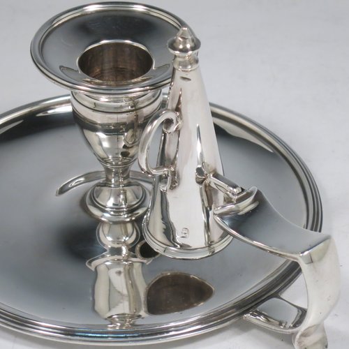 An Antique Georgian Sterling Silver chamber-stick, having a round base, a cast plain scroll handle, an original removable dunce-cap extinguisher, an original removable nozzle, and with applied reed-edged borders. Made by Samuel & George Whitford of London in 1806. The dimensions of this fine hand-made antique silver chamberstick are diameter 13.5 cms (5.25 inches), height 9.5 cms (3.75 inches), and it weighs approx. 326g (10.5 troy ounces).