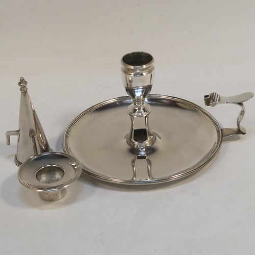 A handsome Antique Georgian Sterling Silver chamber-stick, having a round base, a scroll handle, an original removable dunce-cap extinguisher, an original removable nozzle, and with applied reed-edged borders. This beautiful antique silver chamberstick was made by John Huston of London in 1789. The dimensions of this fine hand-made silver chamberstick are diameter 14 cms (5.5 inches), height 9 cms (3.5 inches), and it weighs approx. 283g (9 troy ounces).