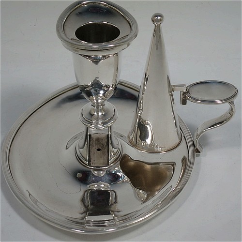 A very handsome pair of Antique Georgian Sterling Silver chamber-sticks, having plain oval bodies, scroll handles with thumb-pieces, original removable dunce-cap extinguishers, original removable nozzles, and with applied reed-edged borders. Made by James Ellis and Co., of Sheffield in 1795. The dimensions of these fine hand-made antique silver chambersticks are length 17 cms (6.75 inches), width 13 cms (5 inches), height 10 cms (4 inches), and they weigh a total of approx. 580g (18.7 troy ounces).