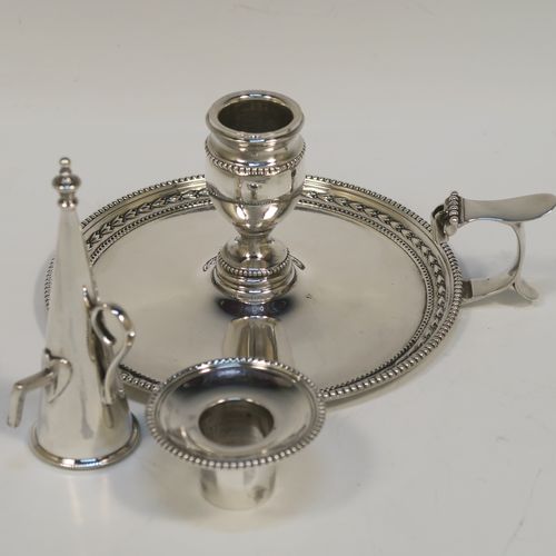 A very pretty Antique Victorian Sterling Silver chamber-stick, having a plain body with a round base, a cast plain scroll side-handle, an original removable dunce-cap extinguisher, an original removable nozzle, and with applied floral and bead-edged borders. This beautiful silver chamberstick was made by James Dixon and Sons of Sheffield of Sheffield in 1900. The dimensions of this fine hand-made antique silver chamberstick are diameter 13.5 cms (5.25 inches), height 9.5 cms (3.75 inches), and it weighs approx. 258g (8.3 troy ounces).