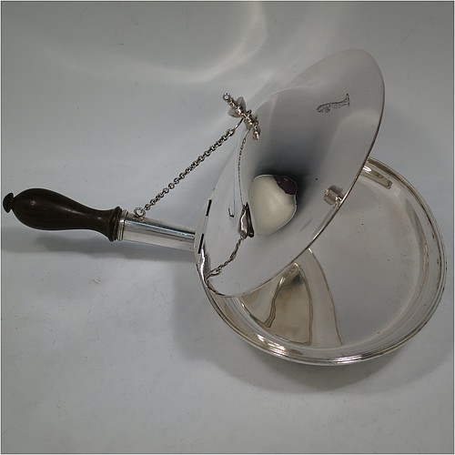A very handsome Antique Georgian Sterling Silver cheese dish, having a very plain oval body with reeded borders, a cast urn-shaped finial, and a flat hidden hinge, attached to a hollow oval hot-water jacket base with removable oak wood-turned handle and a security chain to hold the lid at an angle to reflect heat from fire onto cheese. Made by John King of London in 1788. The dimensions of this fine hand-made antique silver cheese dish are length (inc. handle) 29 cms (11.5 inches), with 25.5 cms (10 inches), height 8 cms (3 inches), and it weighs approx. 850g (27 troy ounces). Please note that this item is crested.