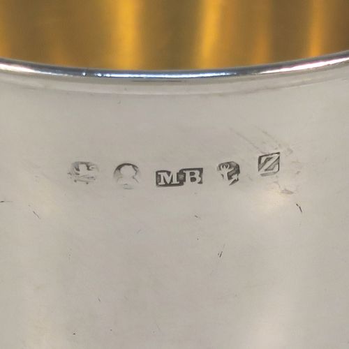 A handsome Antique Georgian Sterling Silver christening mug, having a plain round bellied body with a gold-gilt interior, an acanthus leaf scroll handle, and sitting on a pedestal foot. This elegant antique silver christening mug was made by Matthew Boulton of Birmingham in 1823. The dimensions of this fine hand-made antique silver christening mug are height 9.5 cms (3.75 inches), length 10 cms (4 inches), and it weighs approx. 128g (4 troy ounces).