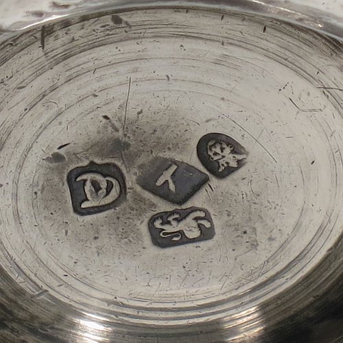 An Antique Georgian Sterling Silver christening mug, having a plain round bellied body, a scroll handle, and sitting on a collet foot. Made in London in 1774. The dimensions of this fine hand-made antique silver christening mug are height 9.5 cms (3.75 inches), diameter at top 6 cms (2.3 inches), and it weighs approx. 175g (5.6 troy ounces).