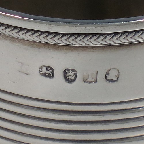 An Antique Georgian Sterling Silver christening mug, having a plain round body with two bands of hand-chased reeded decoration, an applied rope-twist top border, a scroll handle, and sitting on a flat base. Made in London in 1814. The dimensions of this fine hand-made antique silver christening mug are height 9 cms (3.5 inches), length 10 cms (4 inches), and it weighs approx. 129g (4.2 troy ounces).