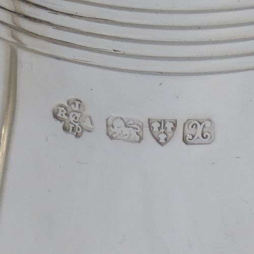 A very elegant Sterling Silver Georgian style christening mug, having a plain round body with two bands of hand-chased reeded decoration, a scroll handle with flat top, and sitting on a flat base. Made by Jays of Oxford Street, London in 1923. The dimensions of this fine hand-made silver christening mug are height 8 cms (3 inches), length 10 cms (4 inches), and it weighs approx. 160g (5.2 troy ounces).