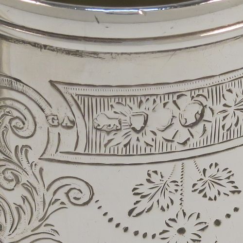 A very pretty Antique Victorian Sterling Silver christening mug, having a round body with straight tapering sides and tucked under belly, with hand-engraved floral and scroll-work decoration, a plain loop handle, a gold-gilt interior, and all sitting on a collet foot. This beautiful silver christening mug was made by George Adams of London in 1878. The dimensions of this fine hand-made antique silver christening mug are height 8 cms (3 inches), diameter at lip 5 cms (2 inches), and it weighs approx. 93g (3 troy ounces).   