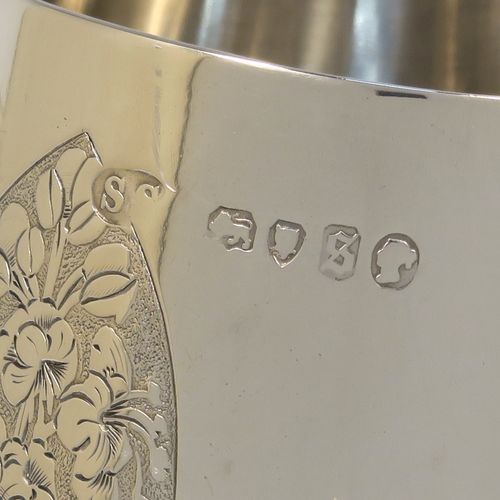 A really beautiful Antique Victorian Sterling Silver christening mug, having a round body with straight tapering sides and tucked under belly, with hand-engraved ferns floral decoration, a plain loop handle, and all sitting on a pedestal foot. This fantastic silver christening mug was made Stephen Smith of London in 1873. The dimensions of this fine hand-made antique silver christening mug are height 11 cms (4.25 inches), diameter at lip 6 cms (2.25 inches), and it weighs approx. 182g (5.9 troy ounces).