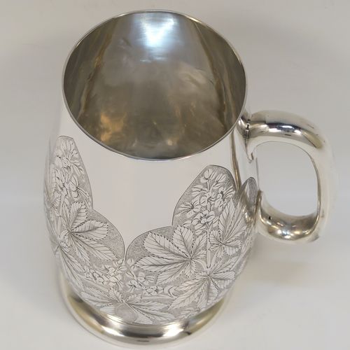 A really beautiful Antique Victorian Sterling Silver christening mug, having a round body with straight tapering sides and tucked under belly, with hand-engraved ferns floral decoration, a plain loop handle, and all sitting on a pedestal foot. This fantastic silver christening mug was made Stephen Smith of London in 1873. The dimensions of this fine hand-made antique silver christening mug are height 11 cms (4.25 inches), diameter at lip 6 cms (2.25 inches), and it weighs approx. 182g (5.9 troy ounces).