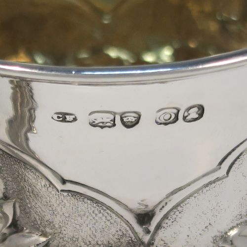 A beautiful Antique Georgian Sterling Silver christening mug, having a round bellied body, with hand-chased floral and leaf style decoration, an acanthus leaf scroll handle, a gold-gilt interior, and sitting on a pedestal foot. This fantastic silver christening mug was made by Charles Fox of London in 1829. The dimensions of this fine hand-made antique silver christening mug are height 9.5 cms (3.75 inches), length 11.5 cms (4.5 inches), and it weighs approx. 142g (4.6 troy ounces).   