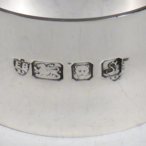 A Sterling Silver christening set, having an egg cup with gold-gilt interior, a spoon with gold-gilt bowl, and a napkin ring. All in a very plain style, and sitting in their original satin and velvet-lined red presentation box. Made by Payne & Son Ltd., of London in 1971/73. The dimensions of this fine hand-made silver christening set are length of spoon 11 cms (4.3 inches), height of egg cup 6 cms (2.25 inches), diameter of napkin ring 4.5 cms (1.75 inches), and the total weight is approx. 97g (3 troy ounces).   