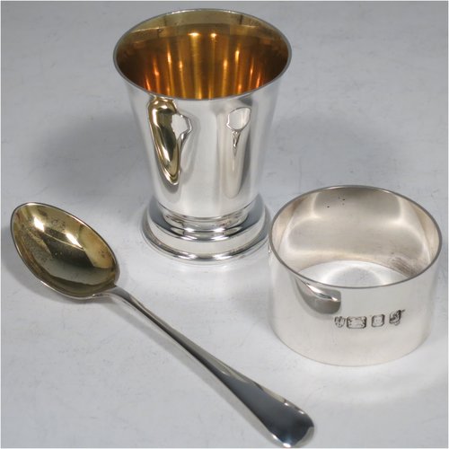A Sterling Silver christening set, having an egg cup with gold-gilt interior, a spoon with gold-gilt bowl, and a napkin ring. All in a very plain style, and sitting in their original satin and velvet-lined red presentation box. Made by Payne & Son Ltd., of London in 1971/73. The dimensions of this fine hand-made silver christening set are length of spoon 11 cms (4.3 inches), height of egg cup 6 cms (2.25 inches), diameter of napkin ring 4.5 cms (1.75 inches), and the total weight is approx. 97g (3 troy ounces).   