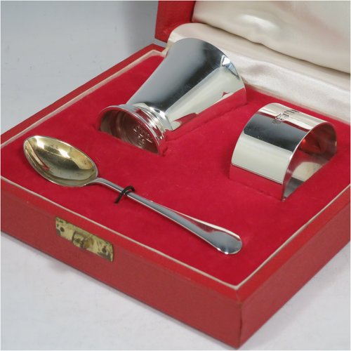 A Sterling Silver christening set, having an egg cup with gold-gilt interior, a spoon with gold-gilt bowl, and a napkin ring. All in a very plain style, and sitting in their original satin and velvet-lined red presentation box. Made by Payne & Son Ltd., of London in 1971/73. The dimensions of this fine hand-made silver christening set are length of spoon 11 cms (4.3 inches), height of egg cup 6 cms (2.25 inches), diameter of napkin ring 4.5 cms (1.75 inches), and the total weight is approx. 97g (3 troy ounces).   