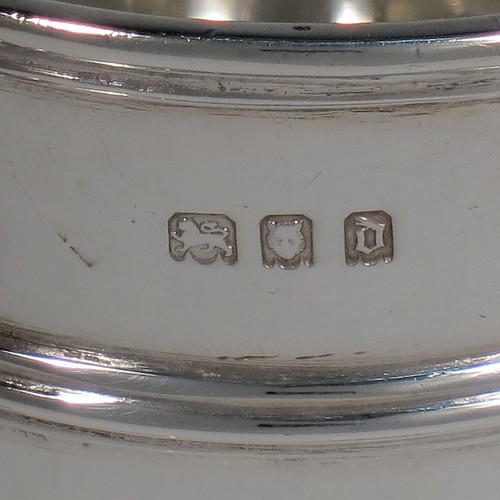 A Sterling Silver christening set consisting of a christening mug with applied strap-work decoration and a scroll handle, and a matching fork and two spoons in the Rattail Hanoverian pattern, all in a cream satin and blue velvet-lined presentation box. The christening mug made in London 1919 and the cutlery from 1895 to 1928. The dimensions of this fine hand-made antique silver christening set are height of mug 9 cms (3.7 inches), length of fork 16 cms (6.25 inches), and with a total weight of approx. 280g (9 troy ounces).