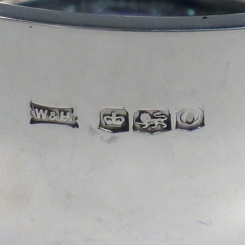 A Sterling Silver christening set, consisting of a plain round baluster bowl sitting on a flat base and a plain Hanoverian pattern spoon, all sitting in an original dark blue satin and velvet-lined presentation box. Made by Walker & Hall of Sheffield in 1931. The dimensions of this fine hand-made silver christening set are length of spoon 14 cms (5.5 inches), diameter of bowl 11 cms (4.3 inches), and the total weight is approx. 185g (6 troy ounces).