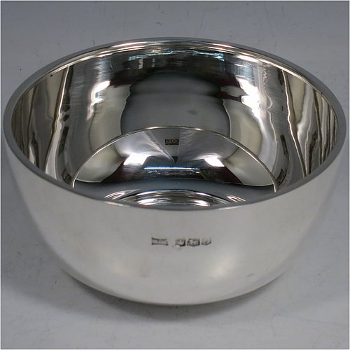 A Sterling Silver christening set, consisting of a plain round baluster bowl sitting on a flat base and a plain Hanoverian pattern spoon, all sitting in an original dark blue satin and velvet-lined presentation box. Made by Walker & Hall of Sheffield in 1931. The dimensions of this fine hand-made silver christening set are length of spoon 14 cms (5.5 inches), diameter of bowl 11 cms (4.3 inches), and the total weight is approx. 185g (6 troy ounces).