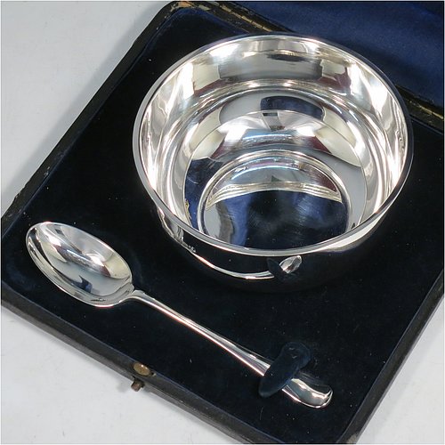 A Sterling Silver christening set, consisting of a plain round baluster bowl sitting on a flat base and a plain Hanoverian pattern spoon, all sitting in an original dark blue satin and velvet-lined presentation box. Made by Walker & Hall of Sheffield in 1931. The dimensions of this fine hand-made silver christening set are length of spoon 14 cms (5.5 inches), diameter of bowl 11 cms (4.3 inches), and the total weight is approx. 185g (6 troy ounces).