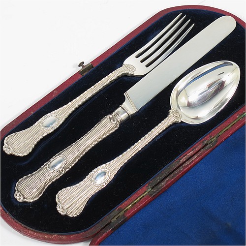 A very handsome and unusual Antique Victorian Sterling Silver christening set, having a knife, fork, and spoon, all with a cast double-struck basket-weave and rope-twist pattern, with vacant oval cartouches, and all sitting in their original dark blue satin and velvet-lined presentation box. Made by Francis Higgins of London in 1861. The dimensions of this fine hand-made antique silver christening set are length of knife 21 cms (8.25 inches), with a total weight of approx. 144g (4.6 troy ounces).