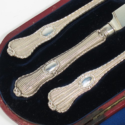 A very handsome and unusual Antique Victorian Sterling Silver christening set, having a knife, fork, and spoon, all with a cast double-struck basket-weave and rope-twist pattern, with vacant oval cartouches, and all sitting in their original dark blue satin and velvet-lined presentation box. Made by Francis Higgins of London in 1861. The dimensions of this fine hand-made antique silver christening set are length of knife 21 cms (8.25 inches), with a total weight of approx. 144g (4.6 troy ounces).