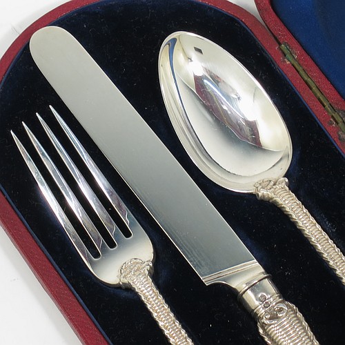 A very handsome and unusual Antique Victorian Sterling Silver christening set, having a knife, fork, and spoon, all with a cast double-struck basket-weave and rope-twist pattern, with vacant oval cartouches, and all sitting in their original dark blue satin and velvet-lined presentation box. Made by Francis Higgins of London in 1861. The dimensions of this fine hand-made antique silver christening set are length of knife 21 cms (8.25 inches), with a total weight of approx. 144g (4.6 troy ounces).