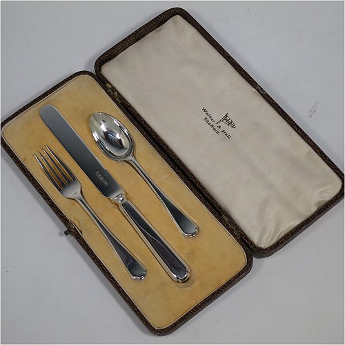 A very handsome Art Deco style Sterling Silver christening set, having a knife, fork, and spoon, all sitting in their original white satin and cream velvet-lined presentation box. Made by Walker and Hall of Sheffield in 1932. The dimensions of this fine hand-made silver christening set are length of knife 19 cms (7.5 inches), with a total weight of approx. 93g (3 troy ounces).